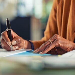 Woman signing truck accident settlement papers