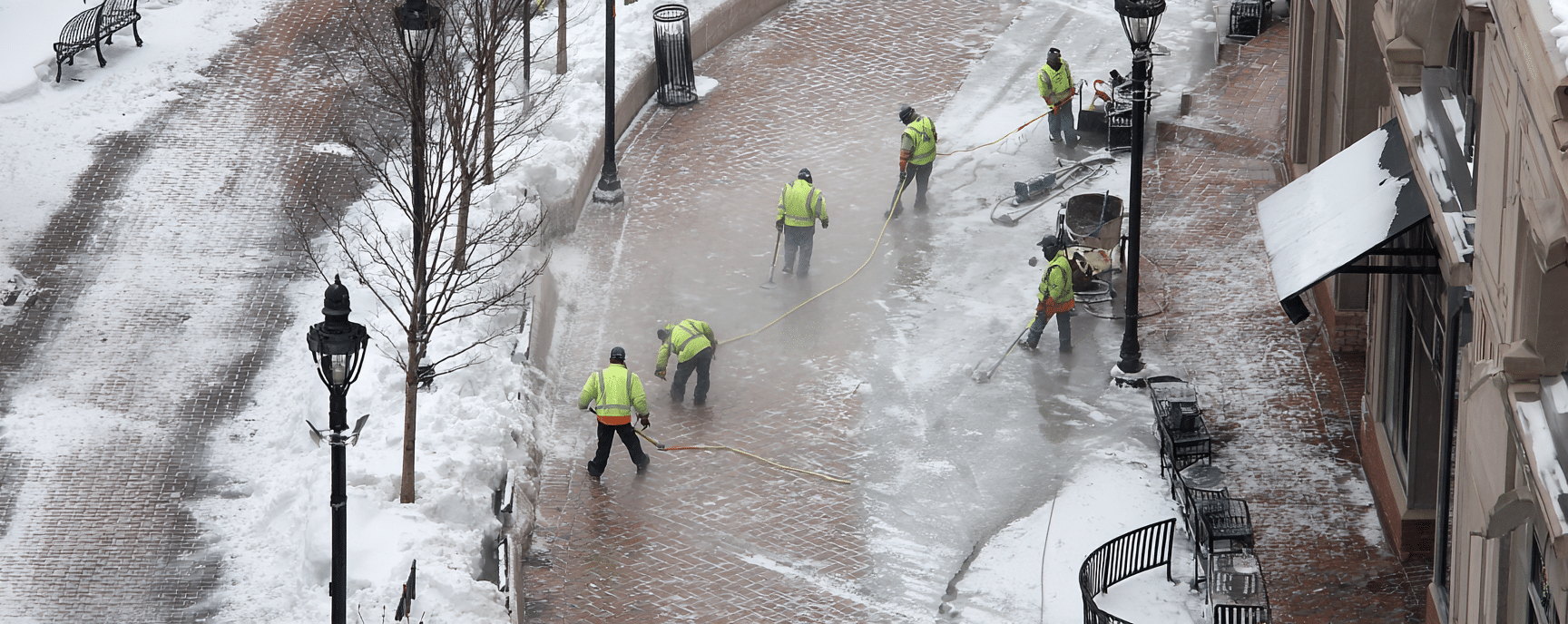 workers salting a walkway in Norwalk